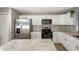 Modern kitchen with stainless steel appliances and white cabinets at 1314 W Highland St, Lakeland, FL 33815