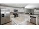 Modern kitchen with white shaker cabinets, stainless steel appliances, and an island at 1314 W Highland St, Lakeland, FL 33815