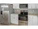 Stainless steel appliances and white cabinets in this kitchen at 1314 W Highland St, Lakeland, FL 33815