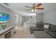 Open living area featuring a sectional sofa, hardwood floors, and a view into the kitchen at 1314 W Highland St, Lakeland, FL 33815