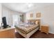Comfortable bedroom with a queen-size bed and private balcony access at 225 Cambria Ave, Davenport, FL 33897
