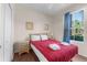 Cozy bedroom with double bed, nightstand and window at 225 Cambria Ave, Davenport, FL 33897