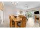 Bright dining area with wood table and chairs, offering views to the living room at 225 Cambria Ave, Davenport, FL 33897