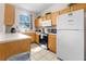 Small kitchen with light wood cabinets and appliances at 225 Cambria Ave, Davenport, FL 33897