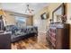 This main bedroom has warm paint and wood flooring, a ceiling fan and a beautiful matching furniture set at 4698 Harts Brook Ln, Mulberry, FL 33860