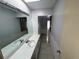 Double vanity bathroom with a view of hallway at 1401 Cr 449, Lake Panasoffkee, FL 33538