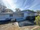 Ranch style home with a light blue exterior and mature trees at 1401 Cr 449, Lake Panasoffkee, FL 33538