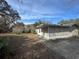 Backyard view of a light blue house with screened porch at 1401 Cr 449, Lake Panasoffkee, FL 33538