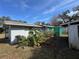 Back of the house showing additional structure and yard at 1401 Cr 449, Lake Panasoffkee, FL 33538