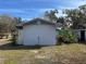 Side view of the house showing a garage and landscaping at 1401 Cr 449, Lake Panasoffkee, FL 33538