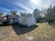 Side view of the house showing the garage and yard at 1401 Cr 449, Lake Panasoffkee, FL 33538