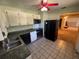 Galley kitchen with stainless steel appliances and ample counter space at 1401 Cr 449, Lake Panasoffkee, FL 33538