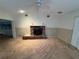 Living room featuring a brick fireplace and ceiling fan at 1401 Cr 449, Lake Panasoffkee, FL 33538