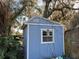 Blue storage shed with white trim and a window at 1401 Cr 449, Lake Panasoffkee, FL 33538