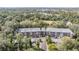 Aerial view of a condo building with ample parking and lush landscaping at 150 El Dorado # 101, Winter Haven, FL 33884