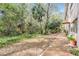 Landscaped backyard, brick path, and abundant greenery at 150 El Dorado # 101, Winter Haven, FL 33884