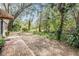 Private backyard with lush landscaping and brick patio at 150 El Dorado # 101, Winter Haven, FL 33884