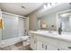Clean bathroom with a tub, shower, and updated vanity at 150 El Dorado # 101, Winter Haven, FL 33884