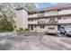 Apartment building with parking and surrounding trees at 150 El Dorado # 101, Winter Haven, FL 33884