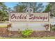 Orchid Springs community entrance sign with landscaping at 150 El Dorado # 101, Winter Haven, FL 33884