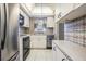 White kitchen cabinets, stainless steel appliances, and a window overlooking the backyard at 150 El Dorado # 101, Winter Haven, FL 33884