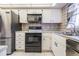 Stainless steel appliances and white cabinets in this well-lit kitchen at 150 El Dorado # 101, Winter Haven, FL 33884