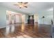 Bright and airy living room with laminate flooring and a ceiling fan at 150 El Dorado # 101, Winter Haven, FL 33884