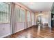 Sunlit living room, hardwood floors, and access to other rooms at 150 El Dorado # 101, Winter Haven, FL 33884