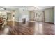 Spacious living area featuring hardwood floors and kitchen view at 150 El Dorado # 101, Winter Haven, FL 33884