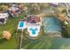 Aerial view of home with private pool and tennis courts near the lake at 5 Loma Linda # 5, Lakeland, FL 33813
