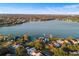 Aerial view of lakefront community with tennis courts and pool at 5 Loma Linda # 5, Lakeland, FL 33813