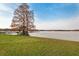 Lake view from a grassy area with two leafless trees at 5 Loma Linda # 5, Lakeland, FL 33813