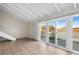 Living room with vaulted ceiling, tile floors, and patio access at 5 Loma Linda # 5, Lakeland, FL 33813