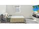 Cozy bedroom with a full-size bed and window at 1125 Michelangelo Ln, Winter Haven, FL 33884