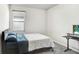Bright bedroom with a bed, window, and a workspace at 1125 Michelangelo Ln, Winter Haven, FL 33884
