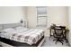 Cozy bedroom with a bed, window, and a workspace at 1125 Michelangelo Ln, Winter Haven, FL 33884