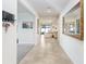 Bright and airy entryway with tile flooring and large mirror at 1125 Michelangelo Ln, Winter Haven, FL 33884