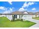 One-story house featuring a two-car garage and well-maintained lawn at 1125 Michelangelo Ln, Winter Haven, FL 33884