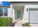 Inviting front entry with light teal door and covered porch at 1125 Michelangelo Ln, Winter Haven, FL 33884
