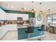 Modern kitchen with teal island and stainless steel appliances at 1125 Michelangelo Ln, Winter Haven, FL 33884