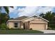 One-story home with light beige exterior, two-car garage, and landscaping at 259 Puma Loop, Groveland, FL 34736
