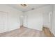 Bright bedroom with wood-look floors and access to a bathroom at 223 Stanley Ave, Frostproof, FL 33843