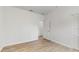 Bedroom with wood-look floors and access to a hallway at 223 Stanley Ave, Frostproof, FL 33843