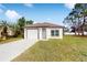 Newly constructed single story home with attached garage and well-manicured lawn at 223 Stanley Ave, Frostproof, FL 33843