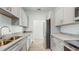 Modern kitchen with stainless steel appliances and granite countertops at 223 Stanley Ave, Frostproof, FL 33843