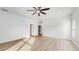 Bright and airy living room with vinyl plank flooring and ceiling fan at 223 Stanley Ave, Frostproof, FL 33843