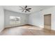 Bright and airy living room with vinyl plank flooring and ceiling fan at 223 Stanley Ave, Frostproof, FL 33843