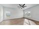 Bright and airy living room with vinyl plank flooring and ceiling fan at 223 Stanley Ave, Frostproof, FL 33843