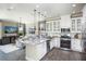 Open concept kitchen with granite countertops and stainless steel appliances at 5721 Gingham Dr, Kissimmee, FL 34758