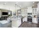 Open kitchen with white cabinets, granite countertops, and island at 5721 Gingham Dr, Kissimmee, FL 34758